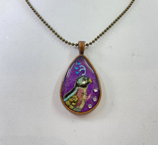 Bird and crystal pendant. Original and beautiful hand painted bird design accented with crystals. Brass frame and brass chain.
