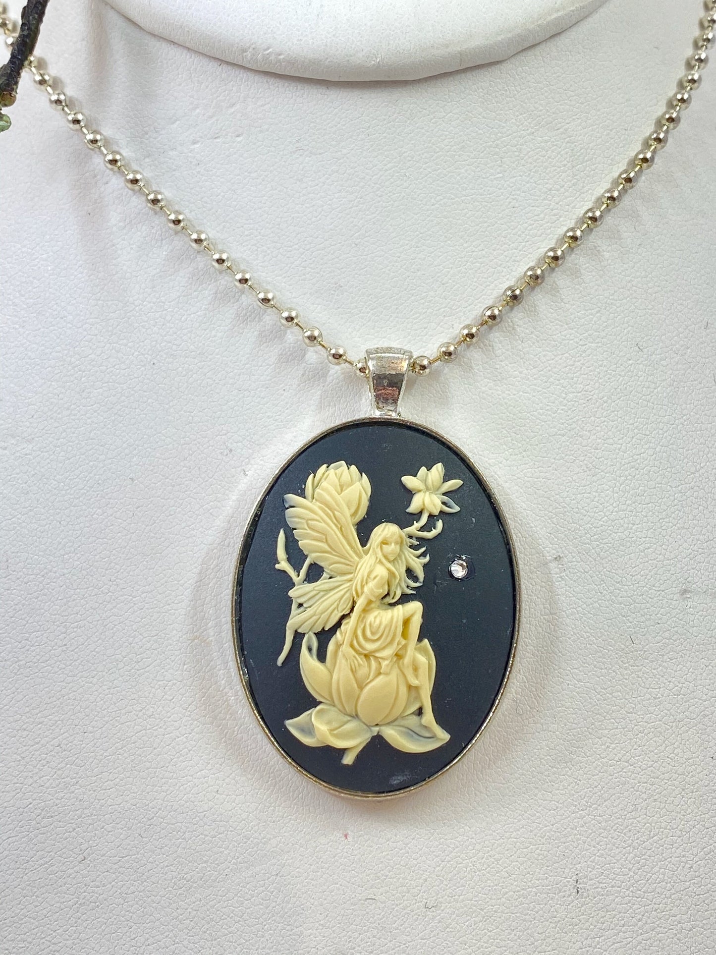 Equisite angel cameo pendant. Set in a silver bezel with a crystal star. Strung on a sterling silver chain.