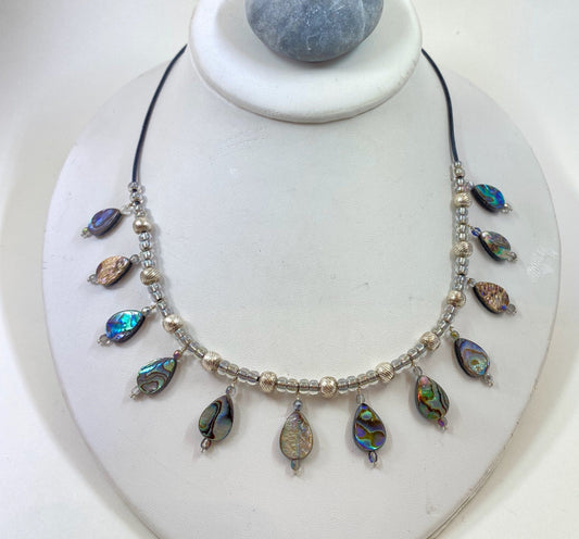 Striking abalone shell and sterling silver beaded necklace. Accented with aurora borealis glass beads.