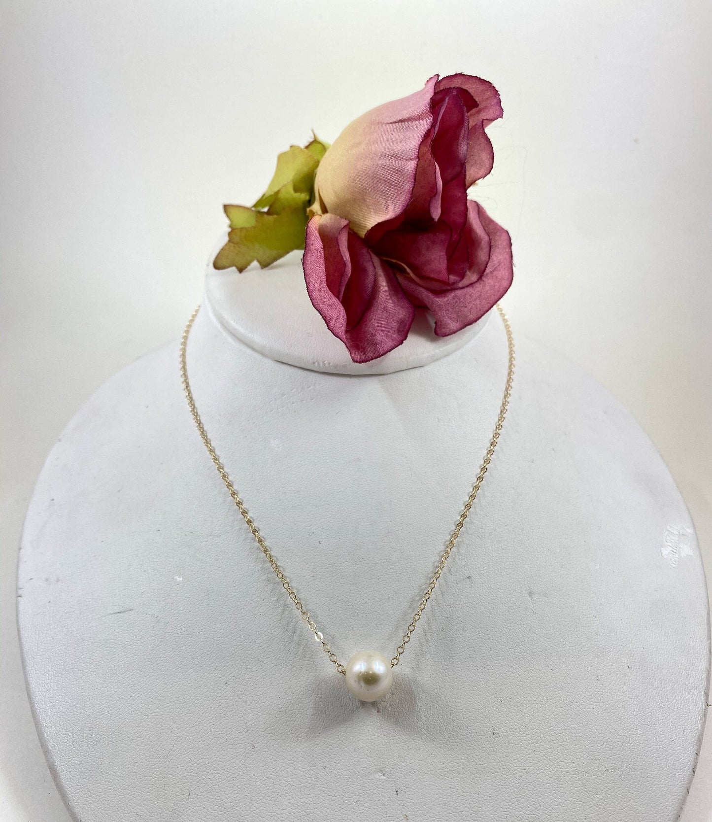 Pearl necklace. This single smooth white pearl slides freely on this lovely quality 14k gold filled chain.