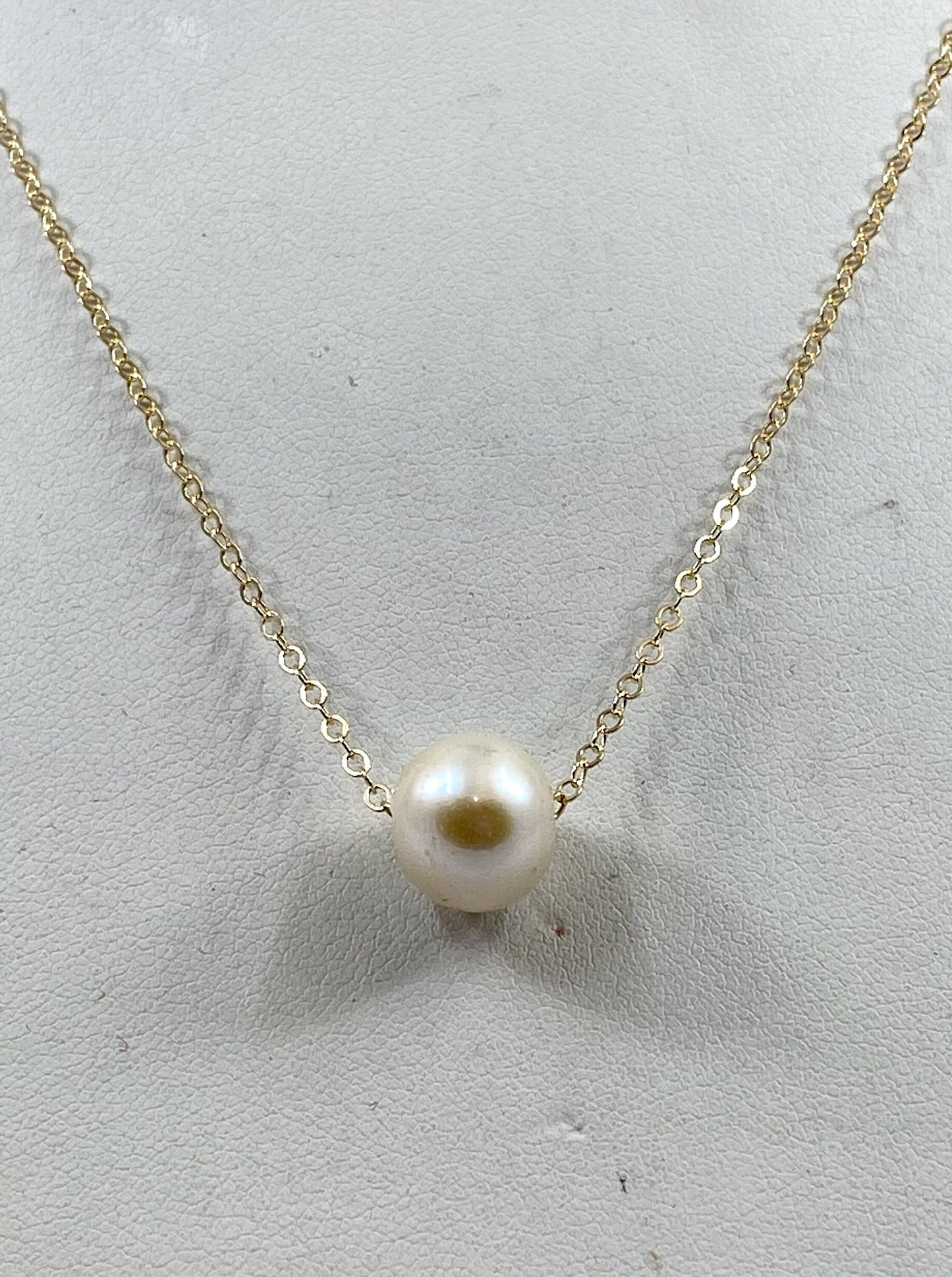 Pearl necklace. This single smooth white pearl slides freely on this lovely quality 14k gold filled chain.