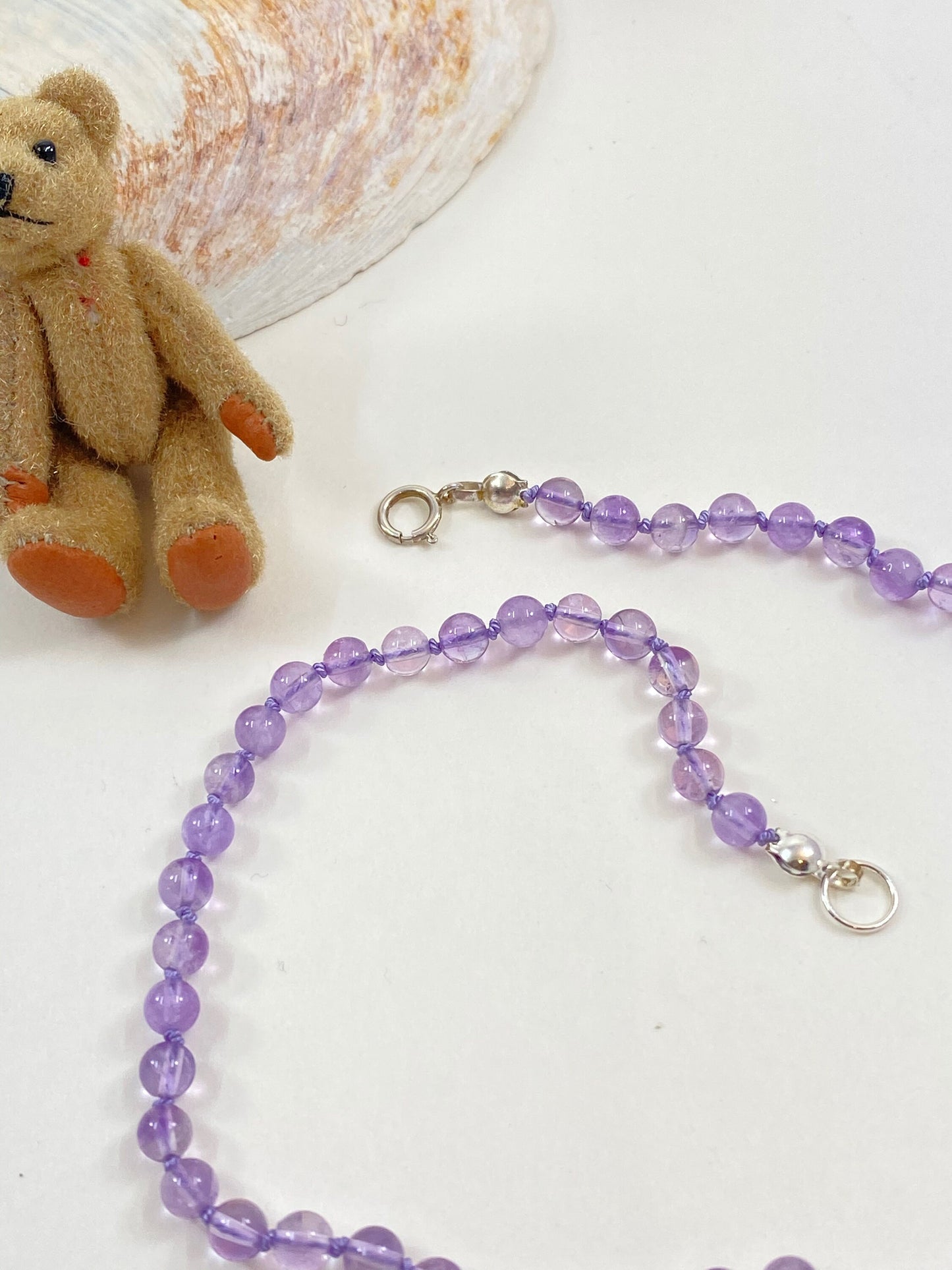 Soft amethyst knotted necklace for babies and toddlers. This necklace is 11" long, including the sterling silver clasp.