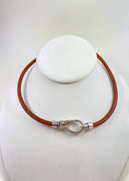 Leather Necklace. Brown Italian leather choker necklace fashioned with a center silver large lobster and loop clasp. Leather is soft.