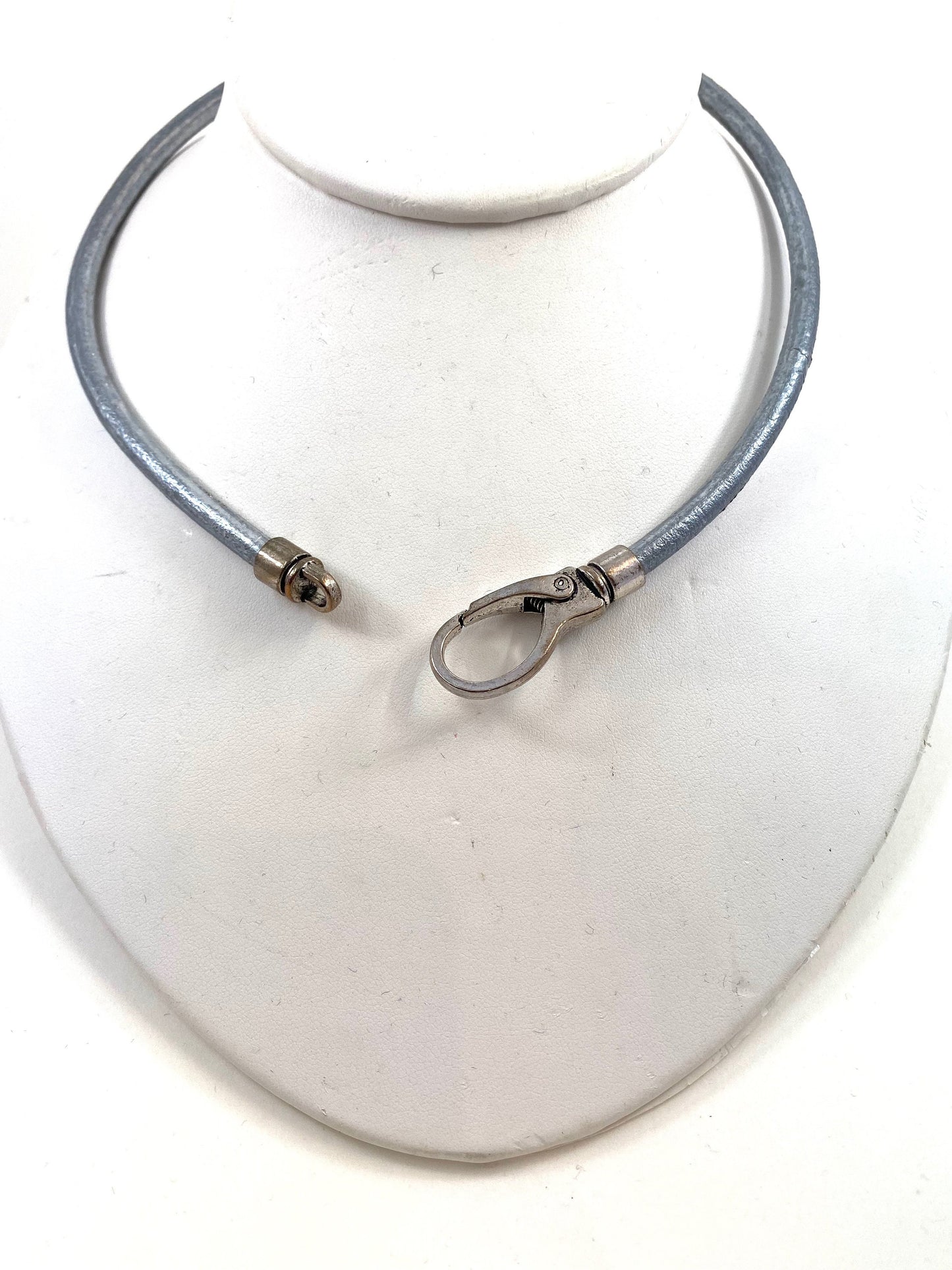 Leather Necklace. Silver-gray Italian leather choker necklace fashioned with a center silver large lobster and loop clasp. Leather is soft.