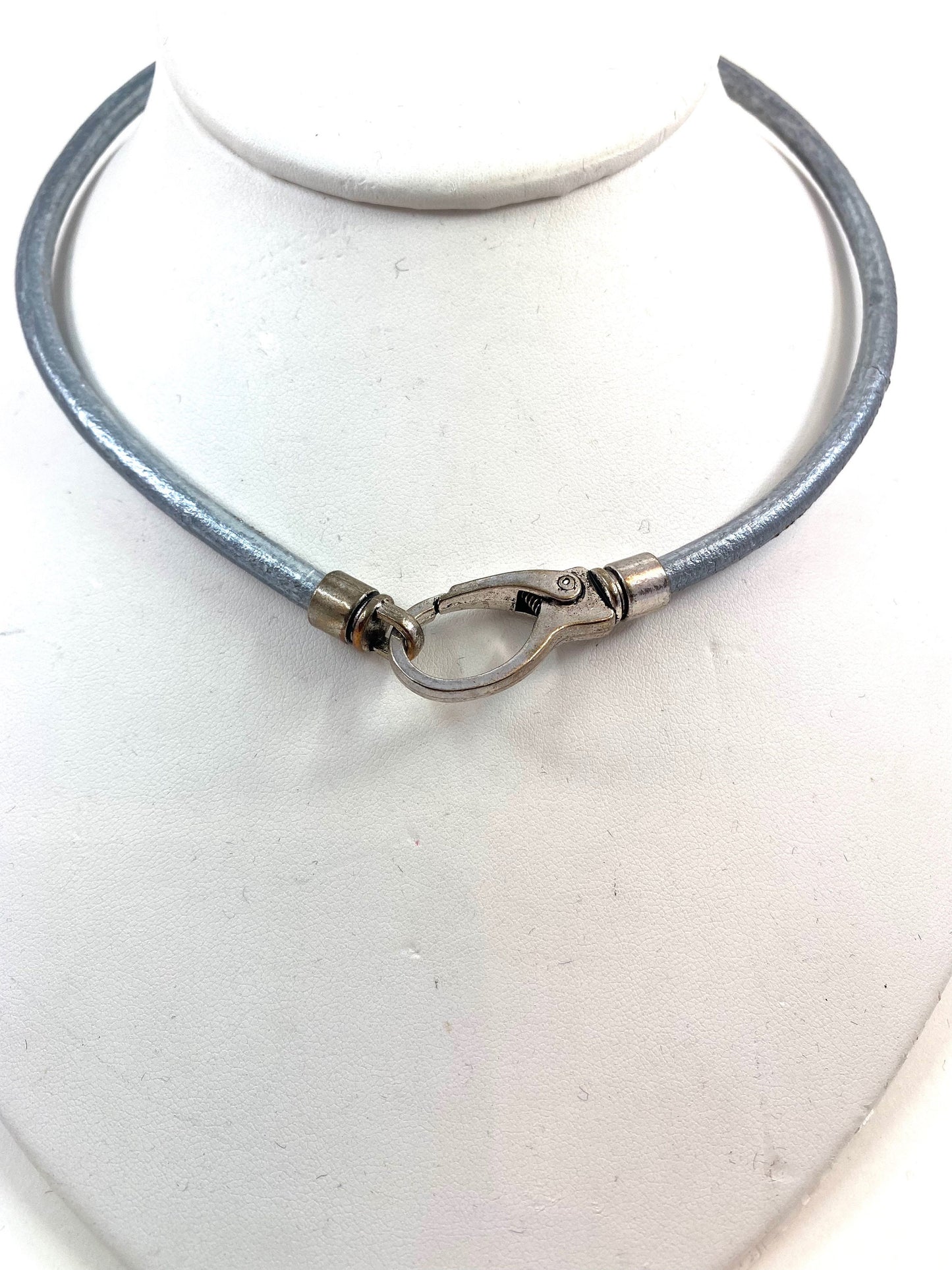 Leather Necklace. Silver-gray Italian leather choker necklace fashioned with a center silver large lobster and loop clasp. Leather is soft.