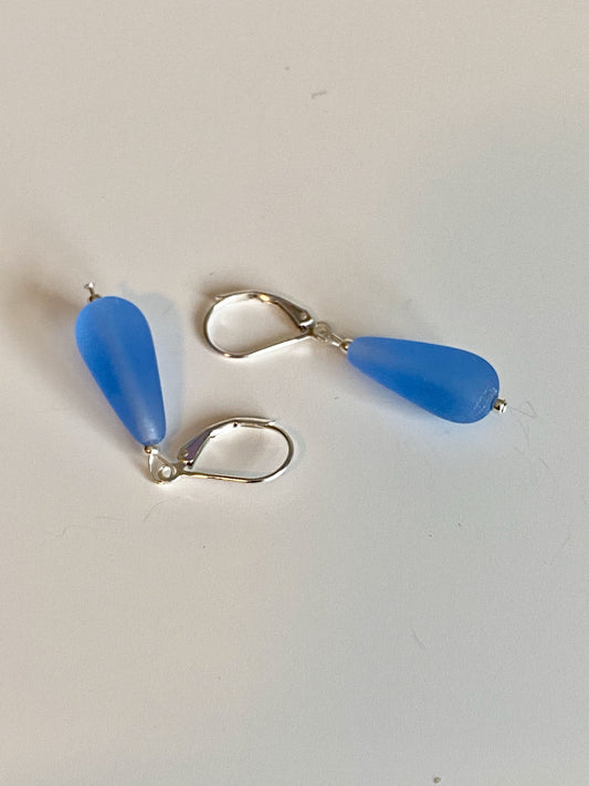 Soft sea glass type frosted sapphire blue teardrop earrings. Fashioned with a quality sterling silver lever back clasp.