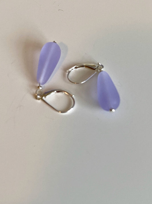Soft sea glass type frosted lilac color teardrop earrings. Fashioned with a quality sterling silver lever back clasp.