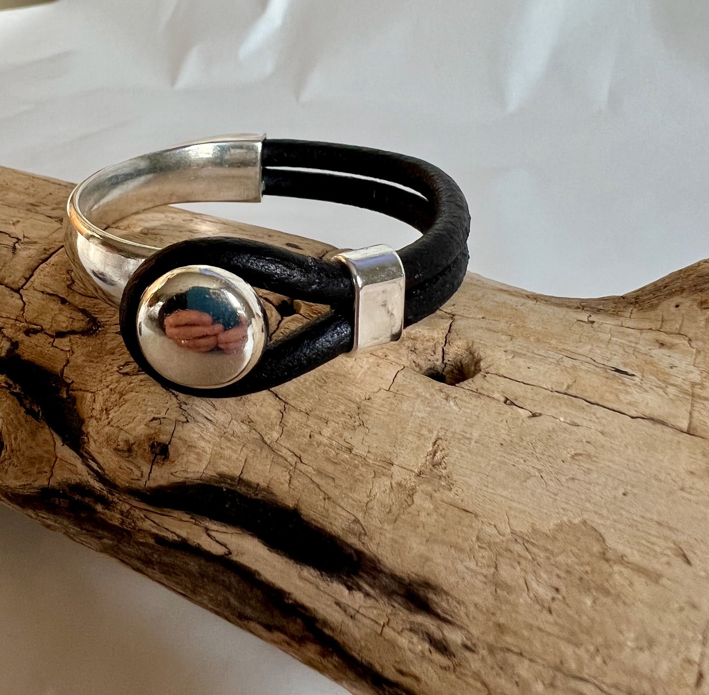 Italian rich black leather bracelet and silver button clasp. Half cuff style.  Soft leather and trendy clasp.