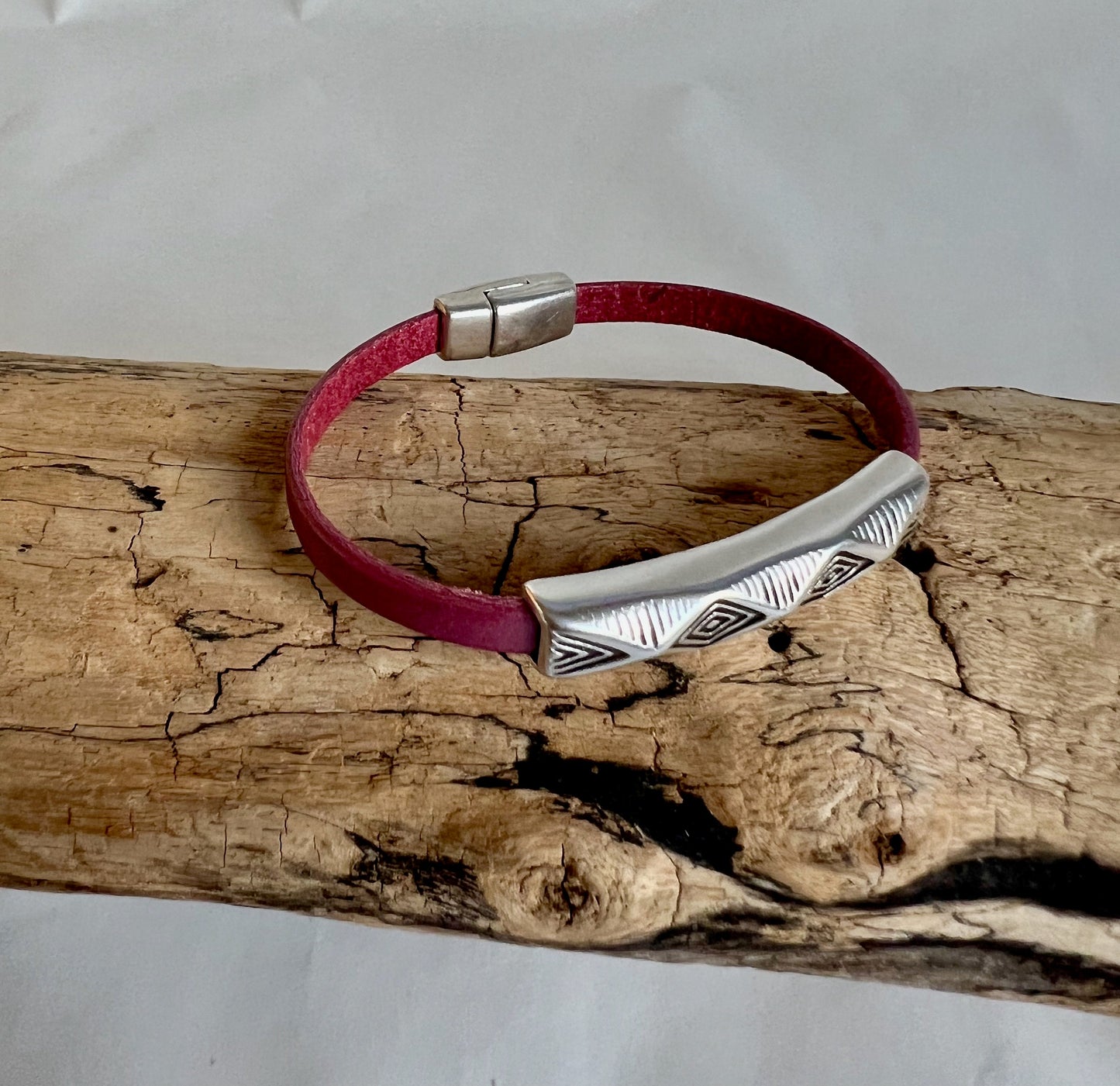 Italian rich soft plum color leather bracelet and silver fine design accent tube .  Silver magnetic clasp. Soft leather and trendy clasp.