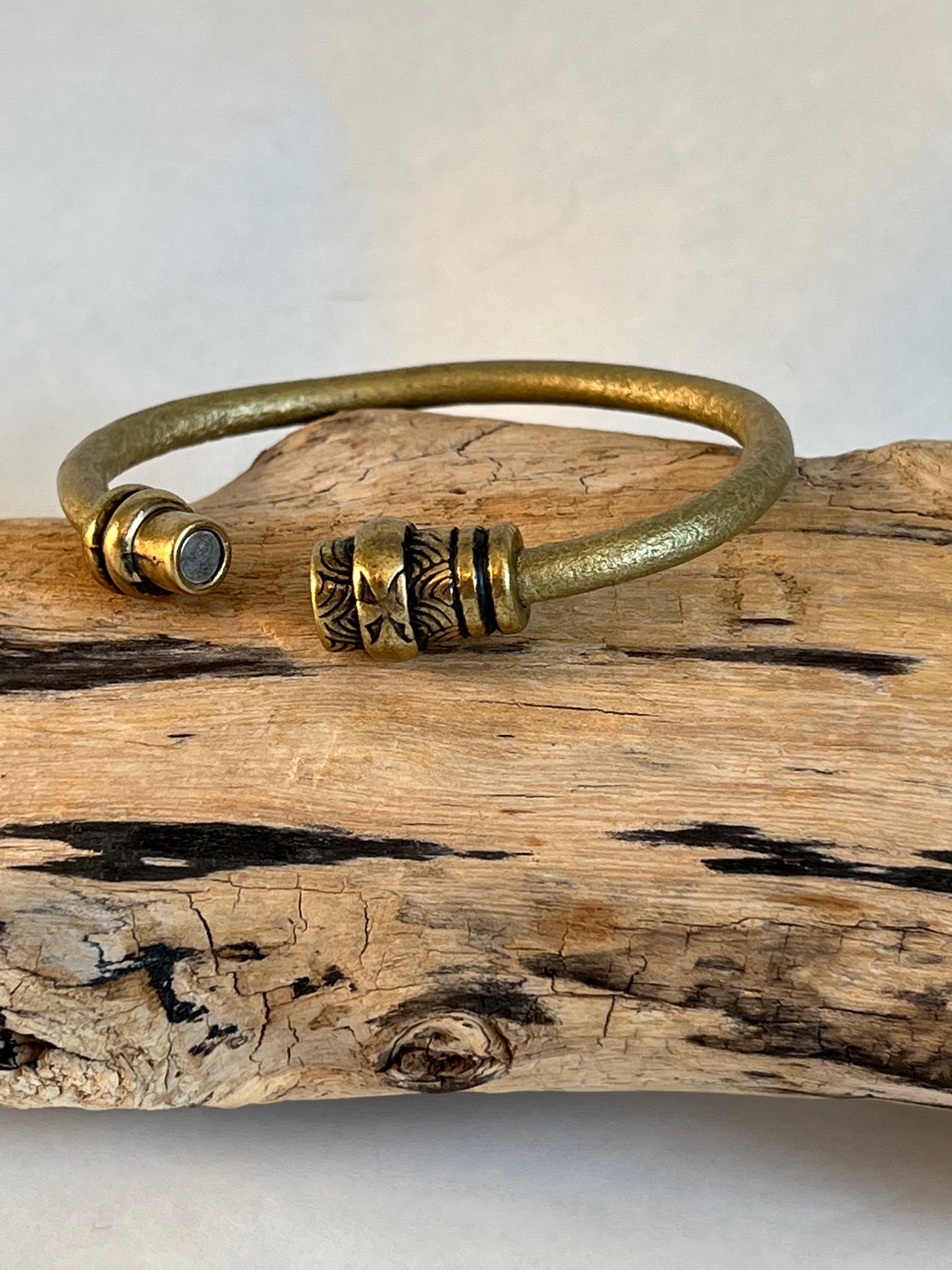 Italian rich gold metallic color leather bracelet with a fine design accent tube .  Silver magnetic clasp. Soft leather and trendy clasp.
