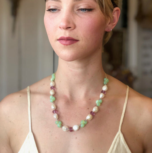 Stunning huge white fresh water pearls accented by purple crystals, lime green glass. Finished with a gold filled magnetic clasp.