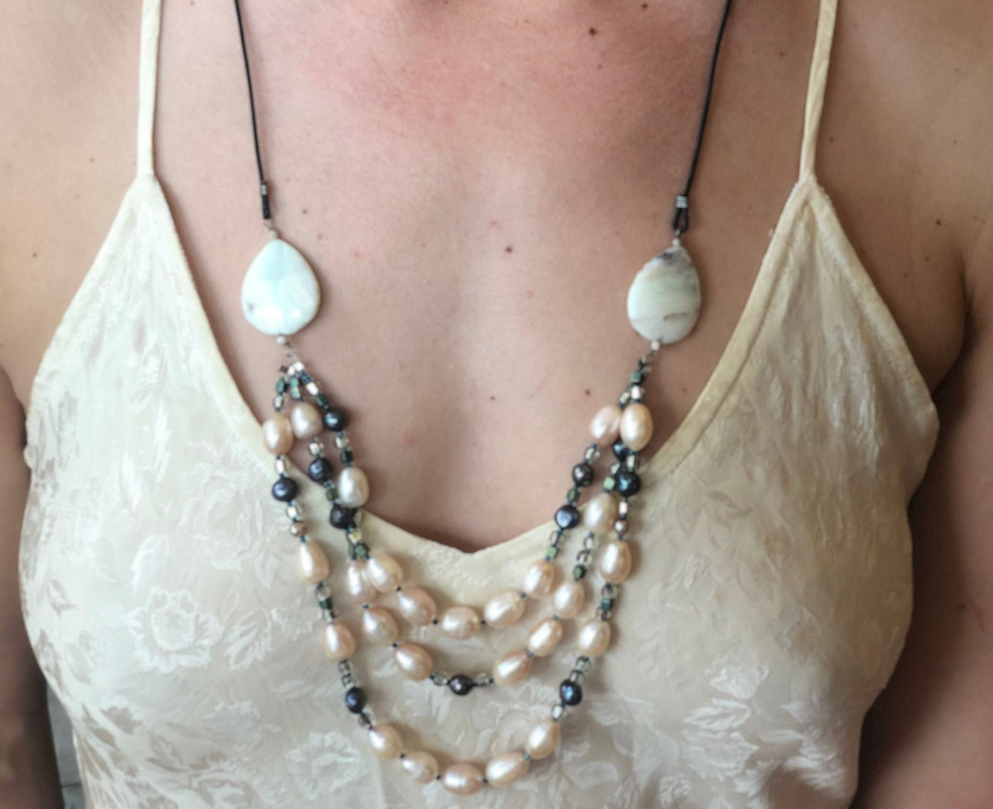 Pearls. Elegant necklace, three strands of soft pink fresh water pearls, chrysoprase gemstones, sterling silver and glass accent beads.