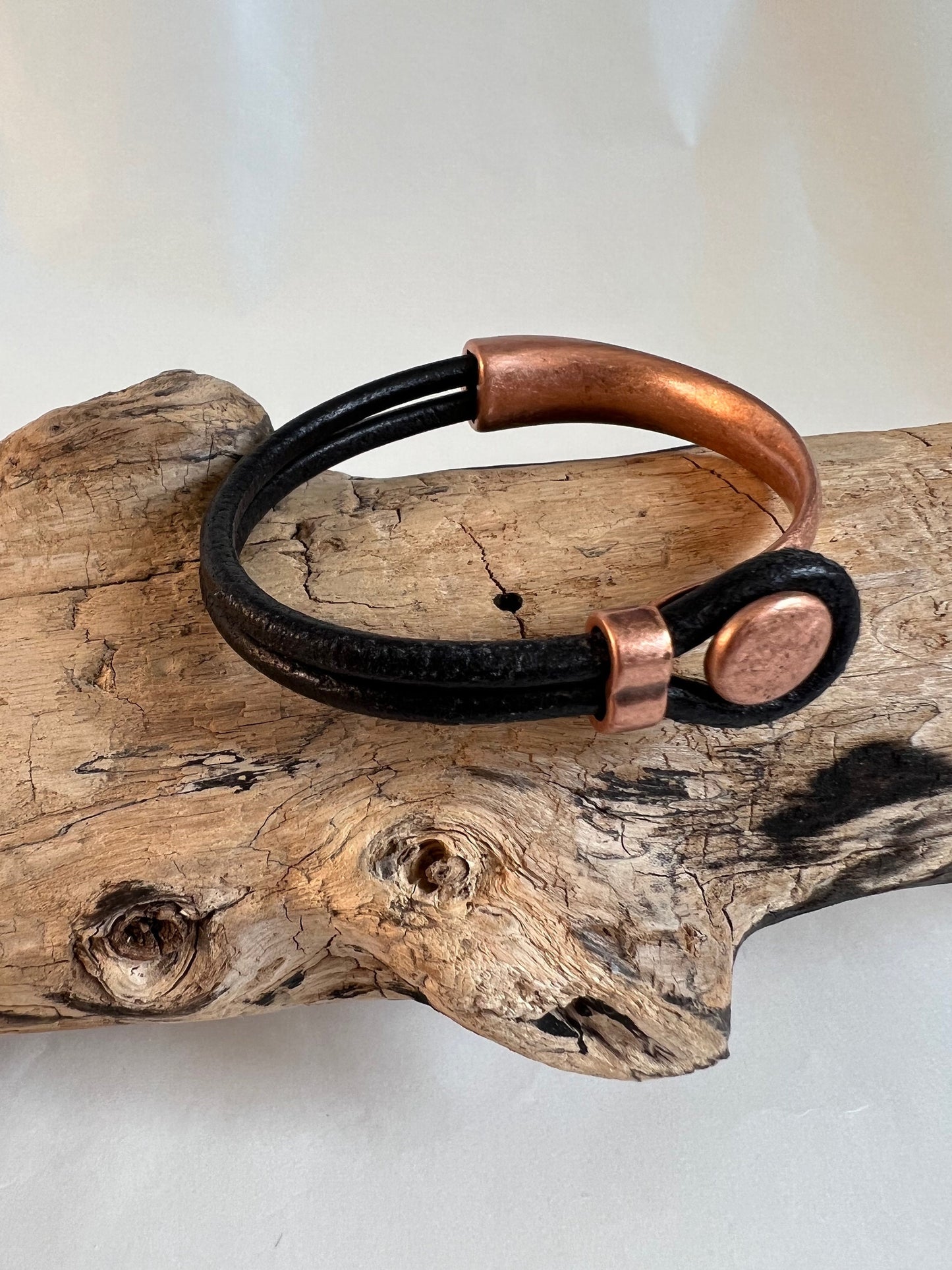 Italian black leather bracelet  with a copper button clasp. Half cuff style. Soft leather and trendy clasp.