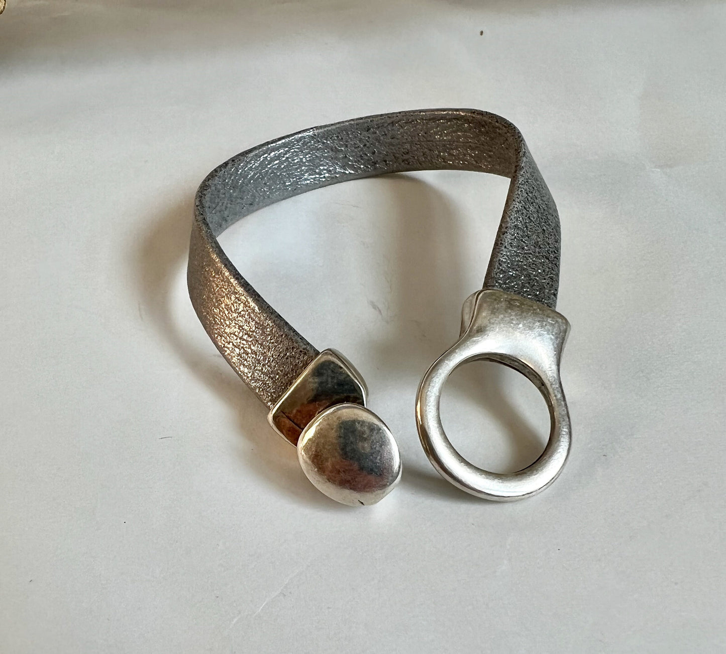 Italian rich silver/gray leather bracelet and silver button clasp.  Soft leather and trendy clasp.