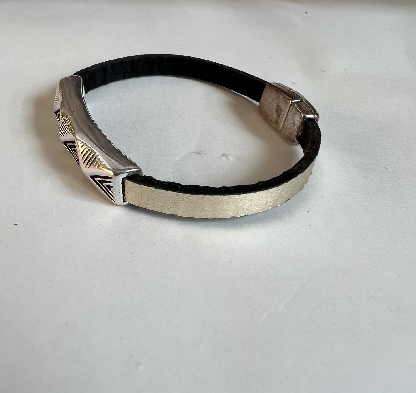 Italian rich gold metallic color leather bracelet with a silver fine design accent tube .  Silver magnetic clasp. Soft leather and trendy clasp.
