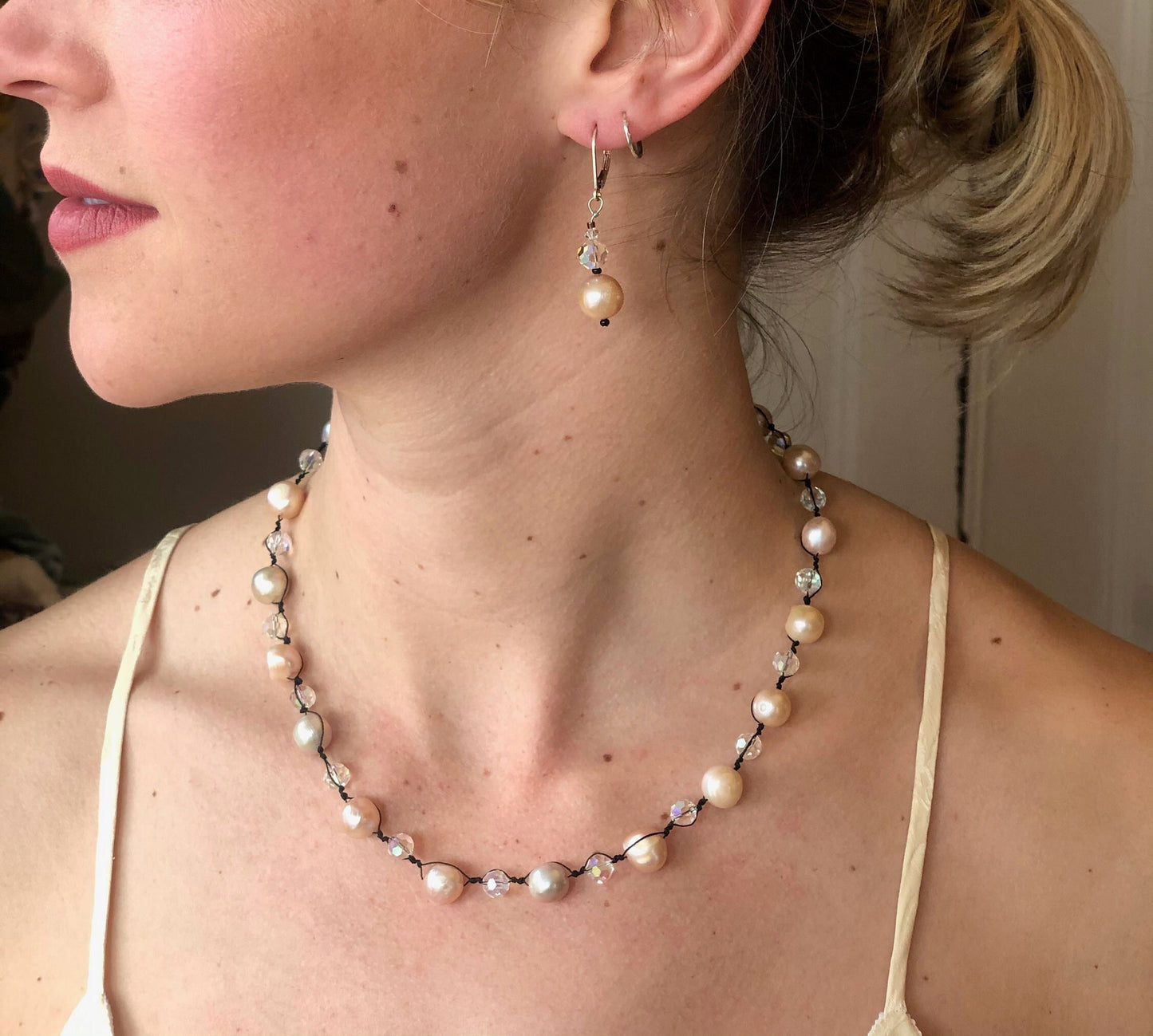 Pearls. Beautiful knotted pale pink fresh water pearl necklace. The necklace is knotted with black silk thread and accented with crystal beads.
