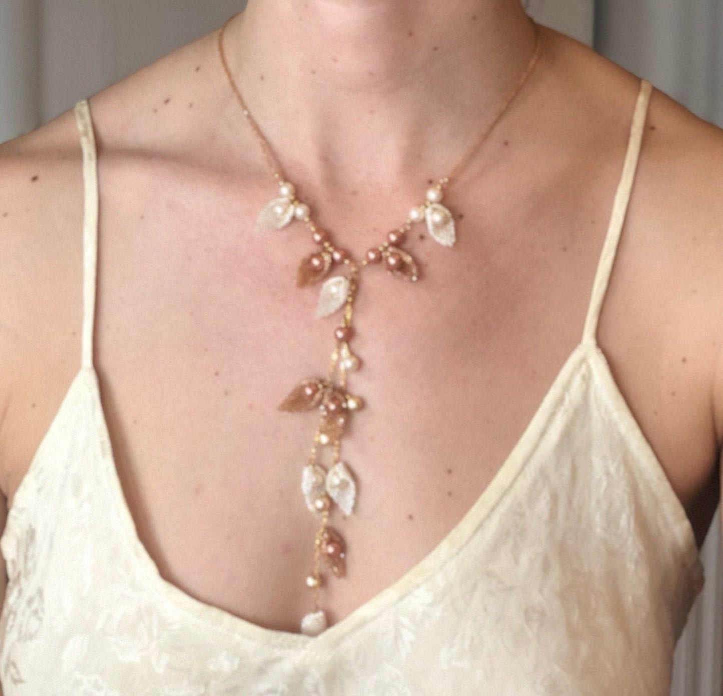 Necklace, handmade, handwoven leaves with set-in pearls makes for a flowing garden necklace.