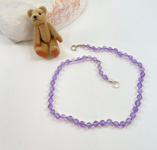 Soft amethyst knotted necklace for babies and toddlers. This necklace is 11" long, including the sterling silver clasp.