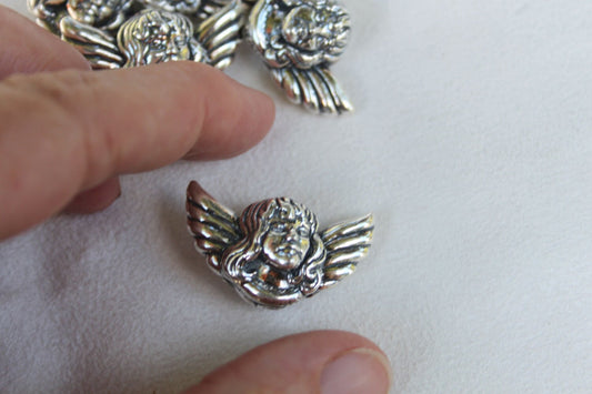 Angel sterling silver beads. Measure 1 1/4" by 3/4 ", hole goes from top to bottom for jewelry stringing
